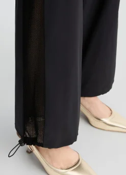Pantaloni con inserto in rete