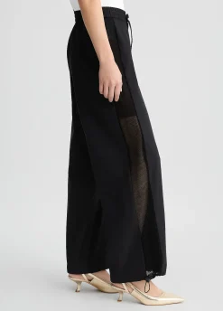 Pantaloni con inserto in rete
