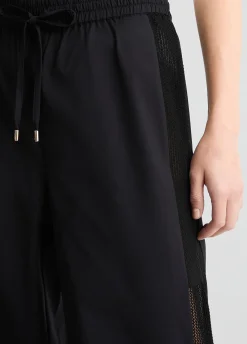 Pantaloni con inserto in rete