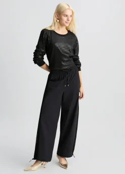 Pantaloni con inserto in rete