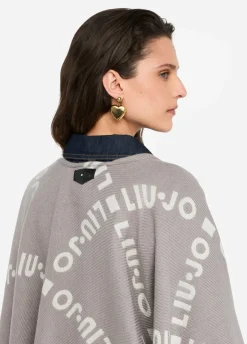 Poncho con logo e frange